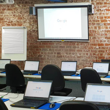computer training room with laptops and a projector