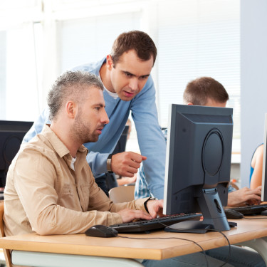 trainer working with client during a class exercise
